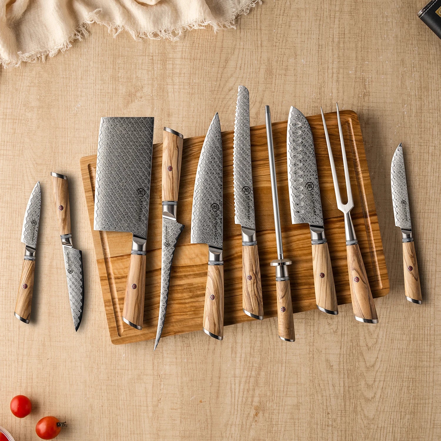 Set of Damascus steel kitchen knives with wood handles on cutting board