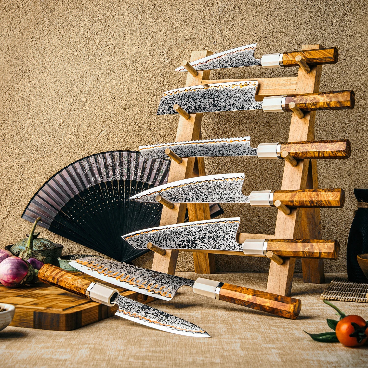 Damascus steel kitchen knives with patterned blades and wooden handles on a display rack